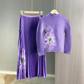 A complete outfit for women, including a long-sleeved t-shirt and a printed pleated skirt – a two-piece set.