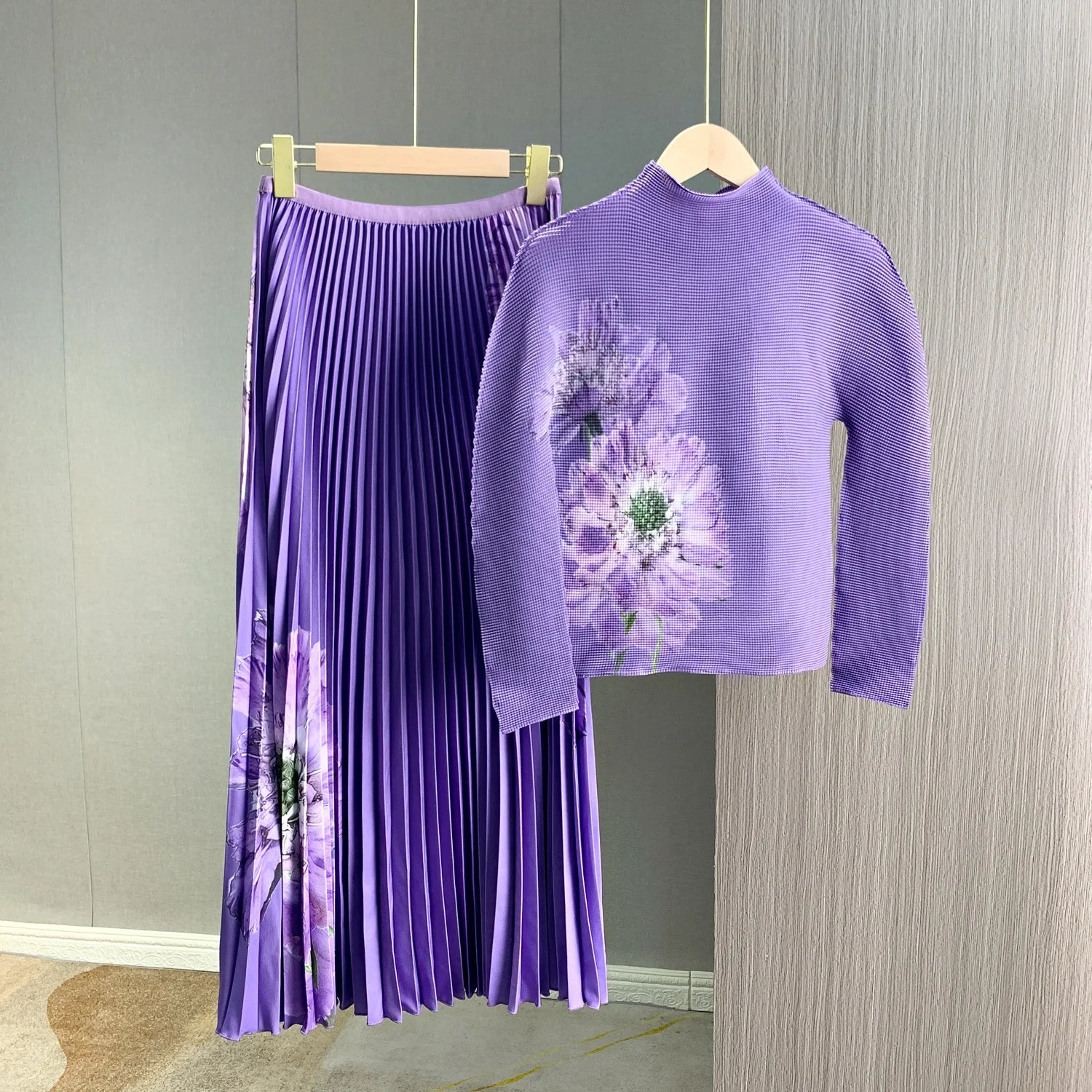 A complete outfit for women, including a long-sleeved t-shirt and a printed pleated skirt – a two-piece set.